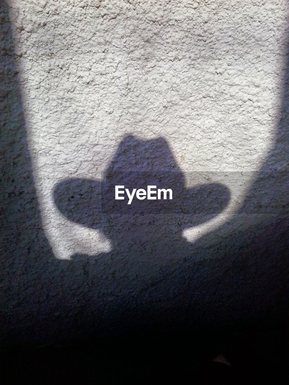 SHADOW OF PERSON ON WALL