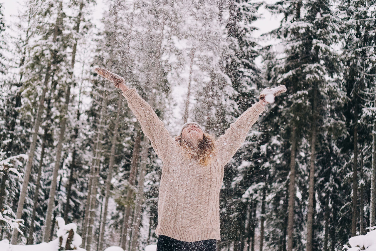 Panoramic shot of person on snow covered trees in forest