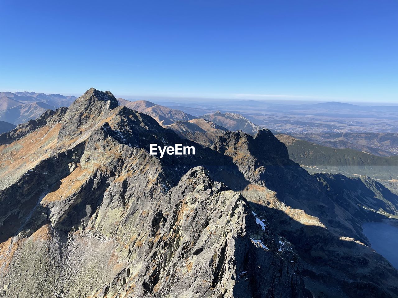 Scenic view of mountains against clear blue sky