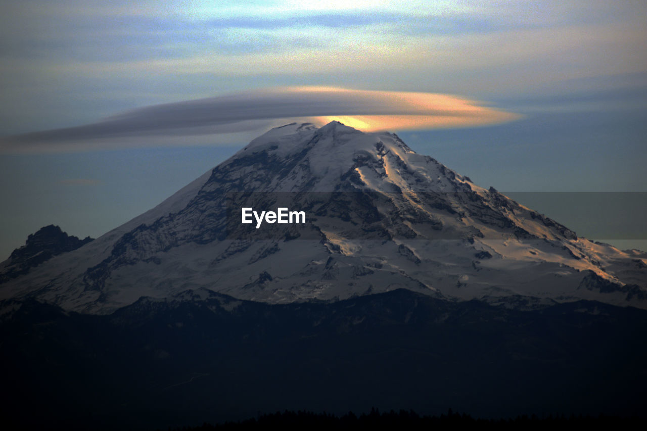 Scenic view of snowcapped mountains against sky during sunset