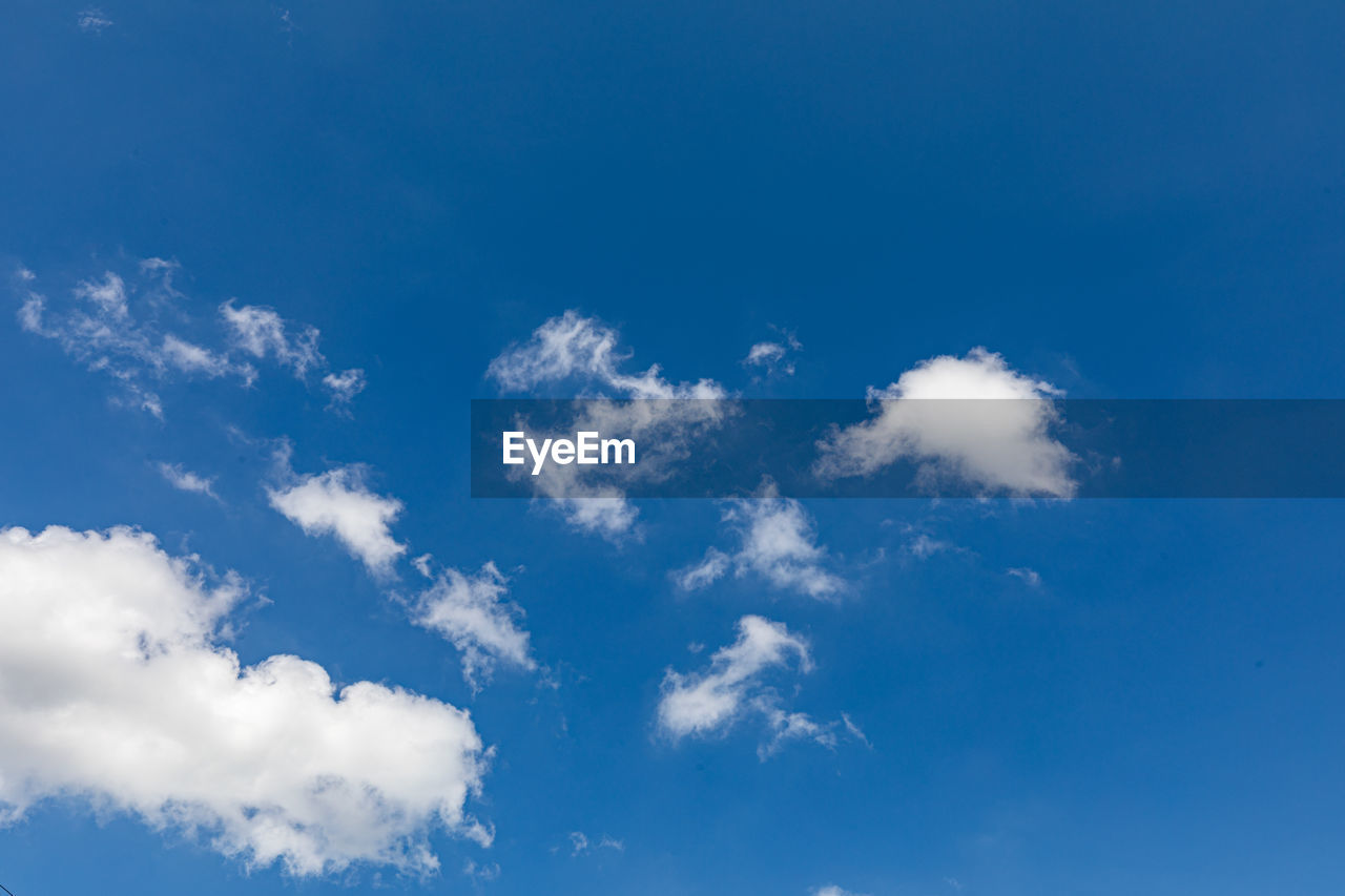 sky, cloud, daytime, blue, nature, environment, backgrounds, white, atmosphere, cloudscape, clear sky, beauty in nature, no people, wind, scenics - nature, outdoors, sunlight, idyllic, fluffy, tranquility, day, overcast, climate, meteorology, summer, light - natural phenomenon, space, bright, mid-air, azure, low angle view, panoramic, vibrant color, high up, flying, copy space