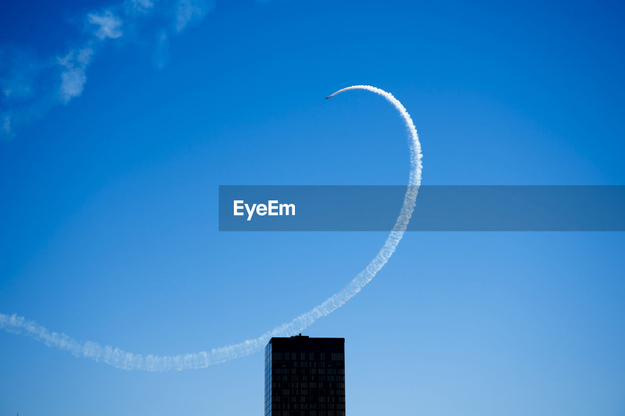 low angle view of modern building against blue sky