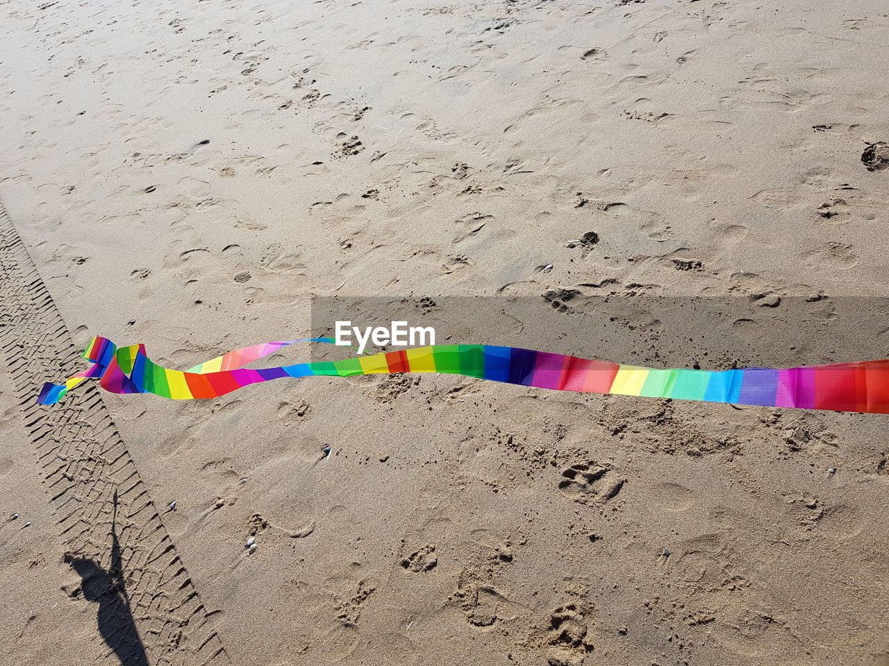 MULTI COLORED UMBRELLA ON SAND