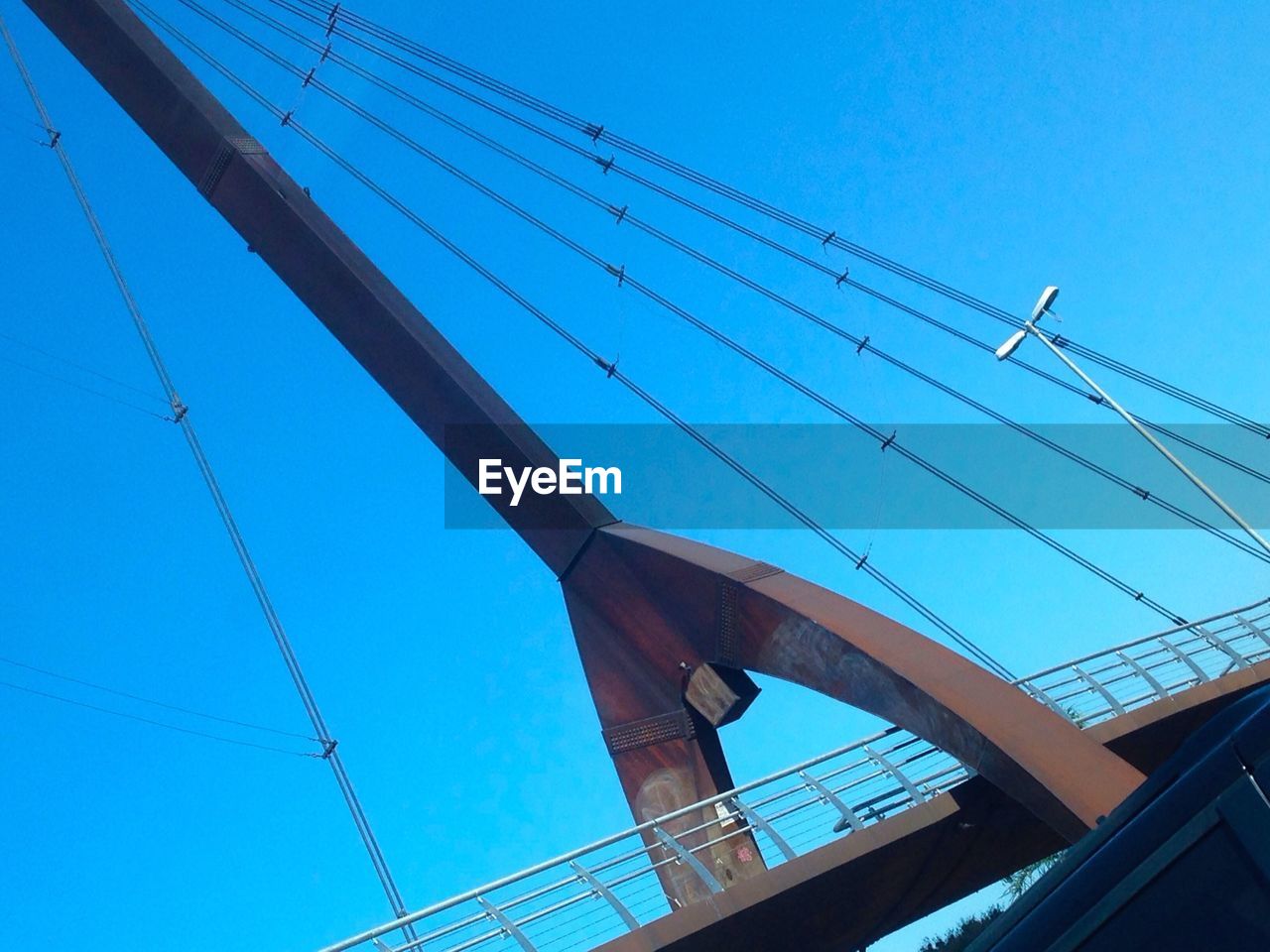 LOW ANGLE VIEW OF POWER LINES AGAINST BLUE SKY