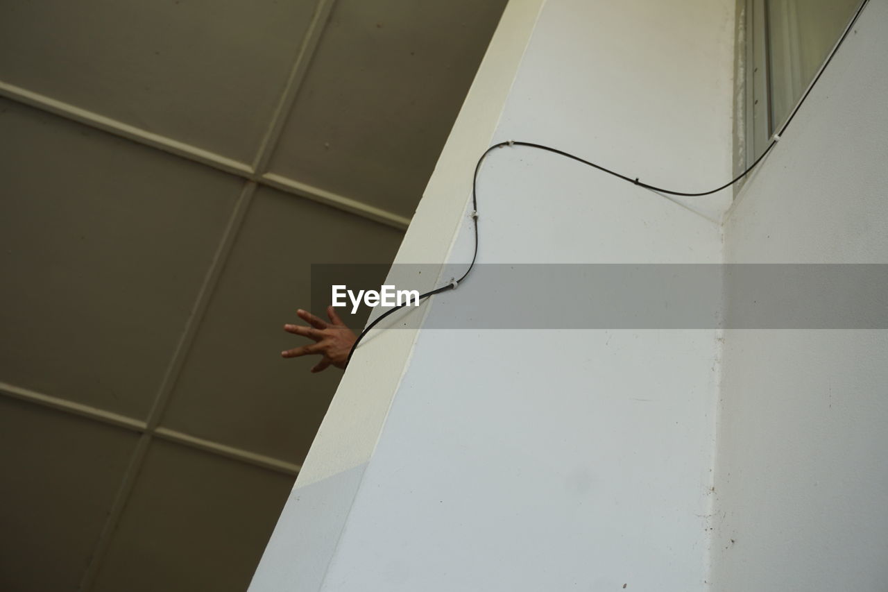 CLOSE-UP OF HAND ON WALL