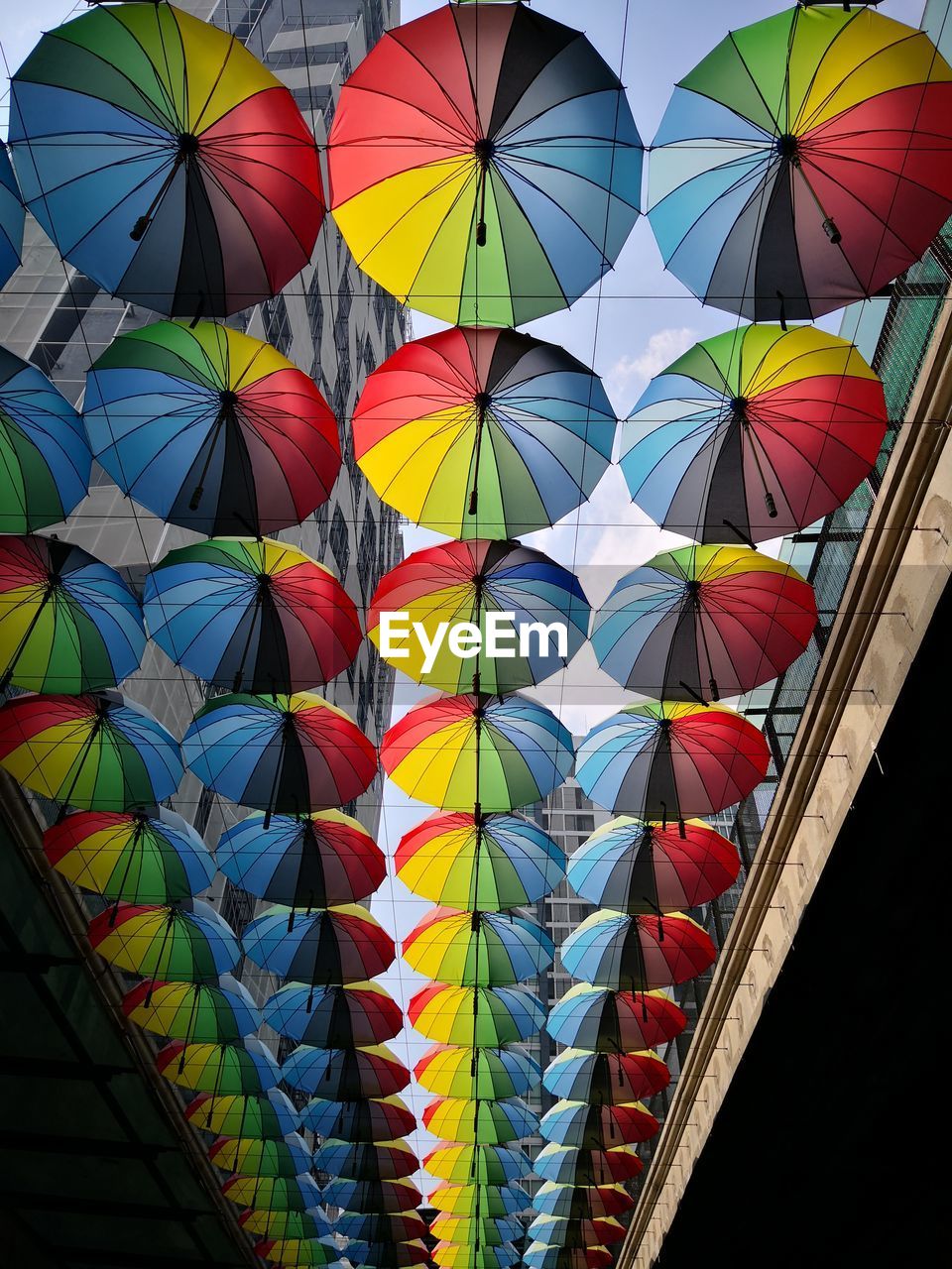 Low angle view of multi colored umbrellas hanging at market stall