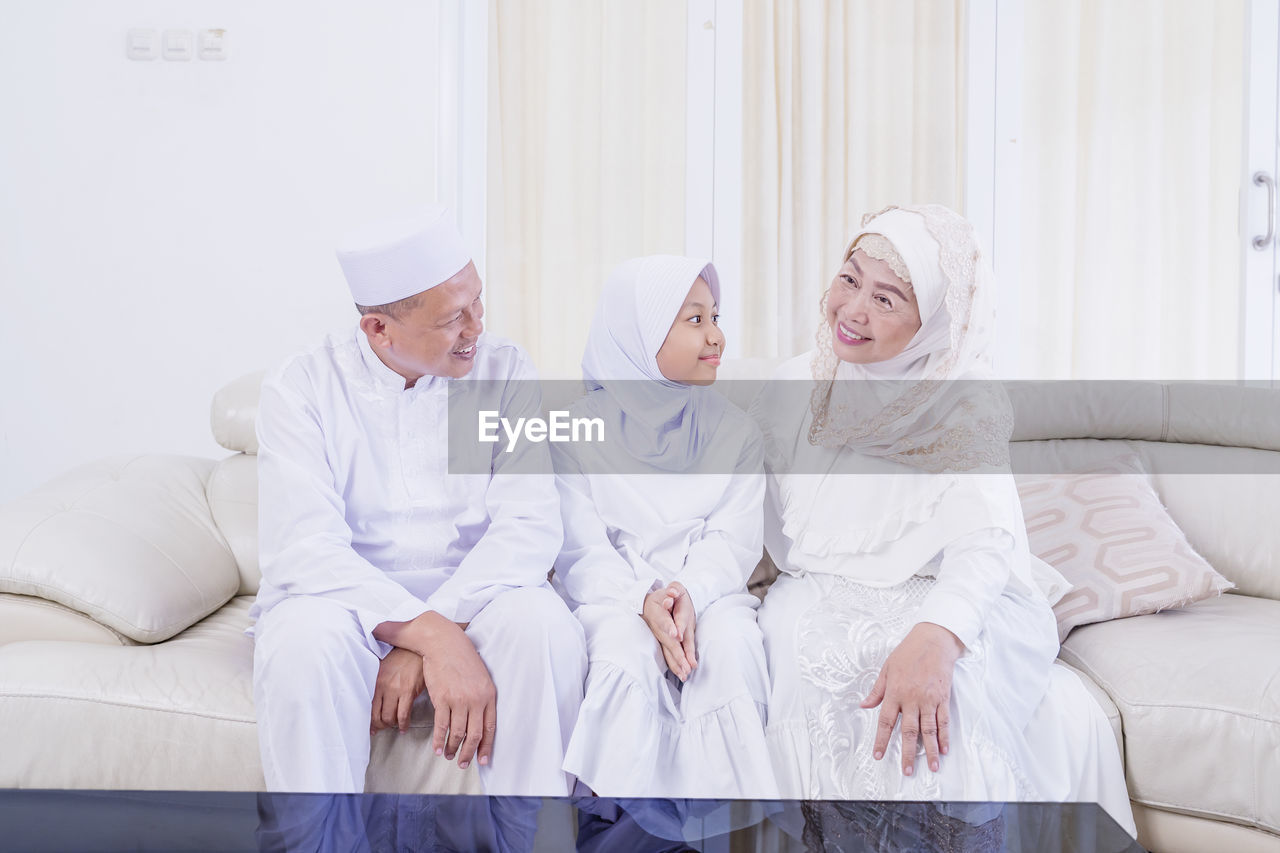 GROUP OF PEOPLE AGAINST WHITE BACKGROUND