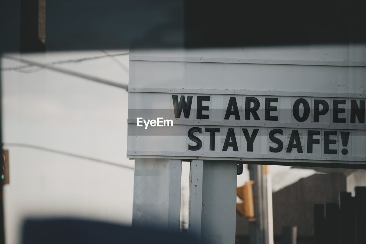 Outdoor sign telling people to stay safe.