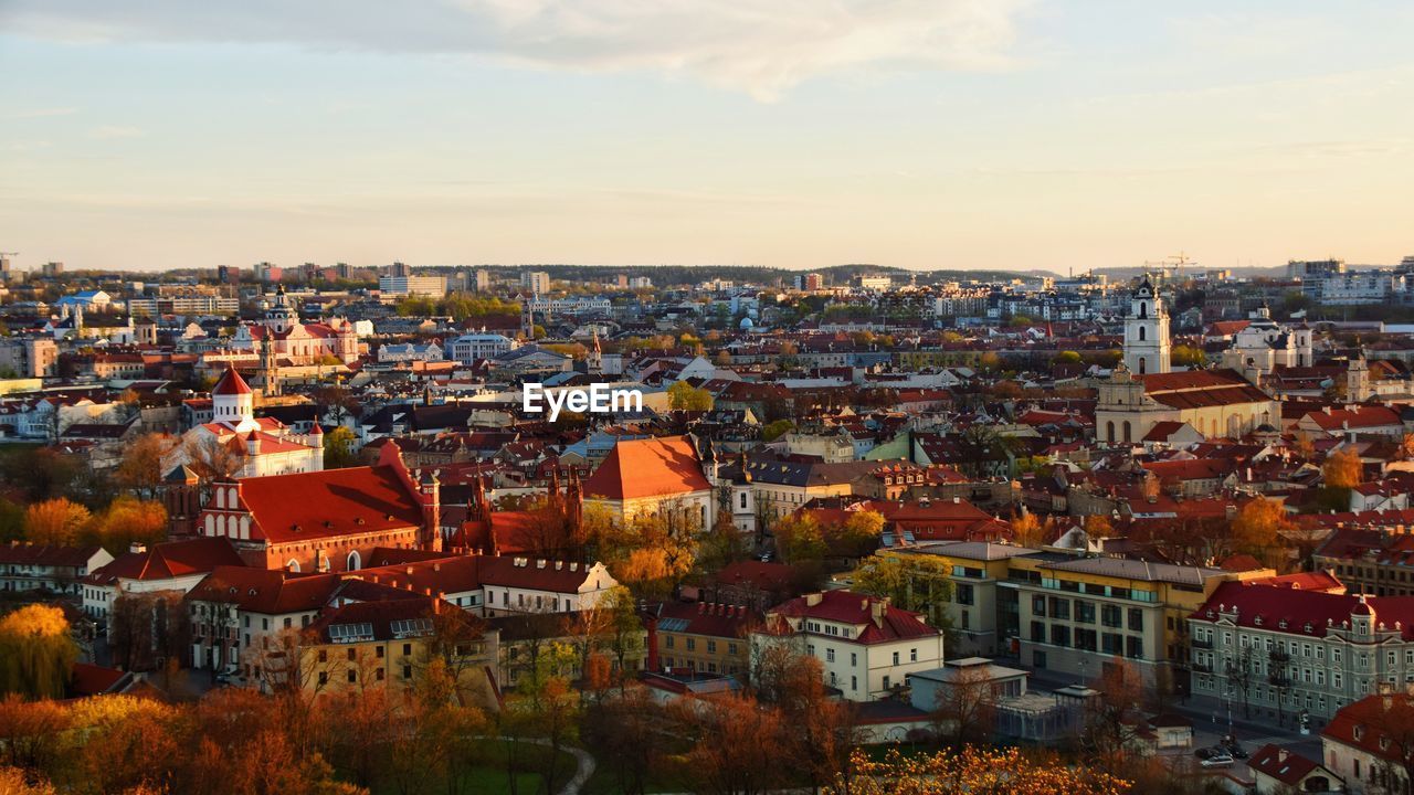 High angle shot of townscape against sky at sunset