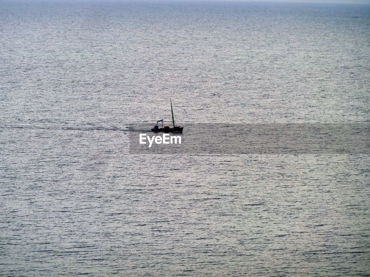 Boat sailing on sea against sky