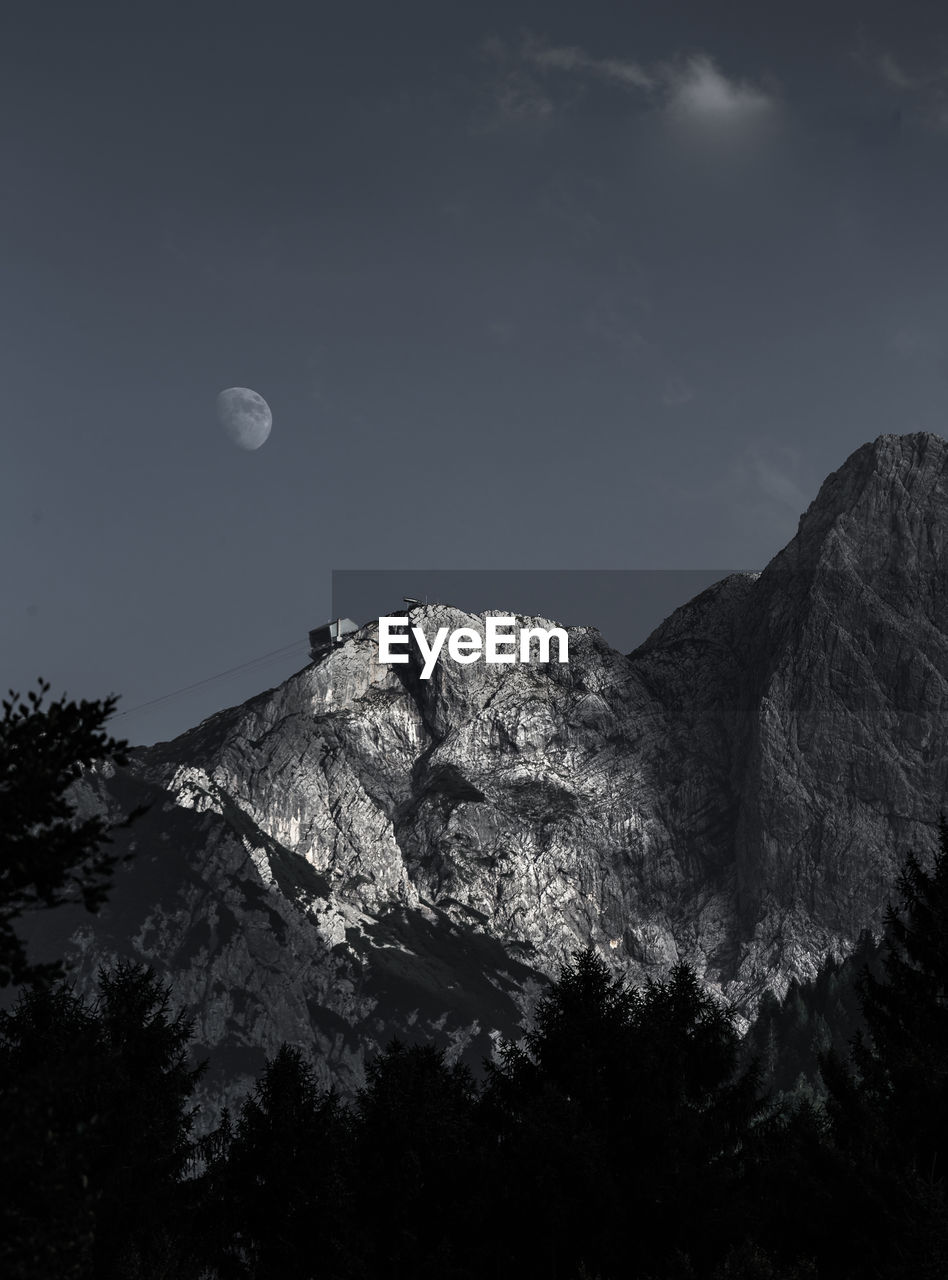 Low angle view of mountain against clear sky at dusk