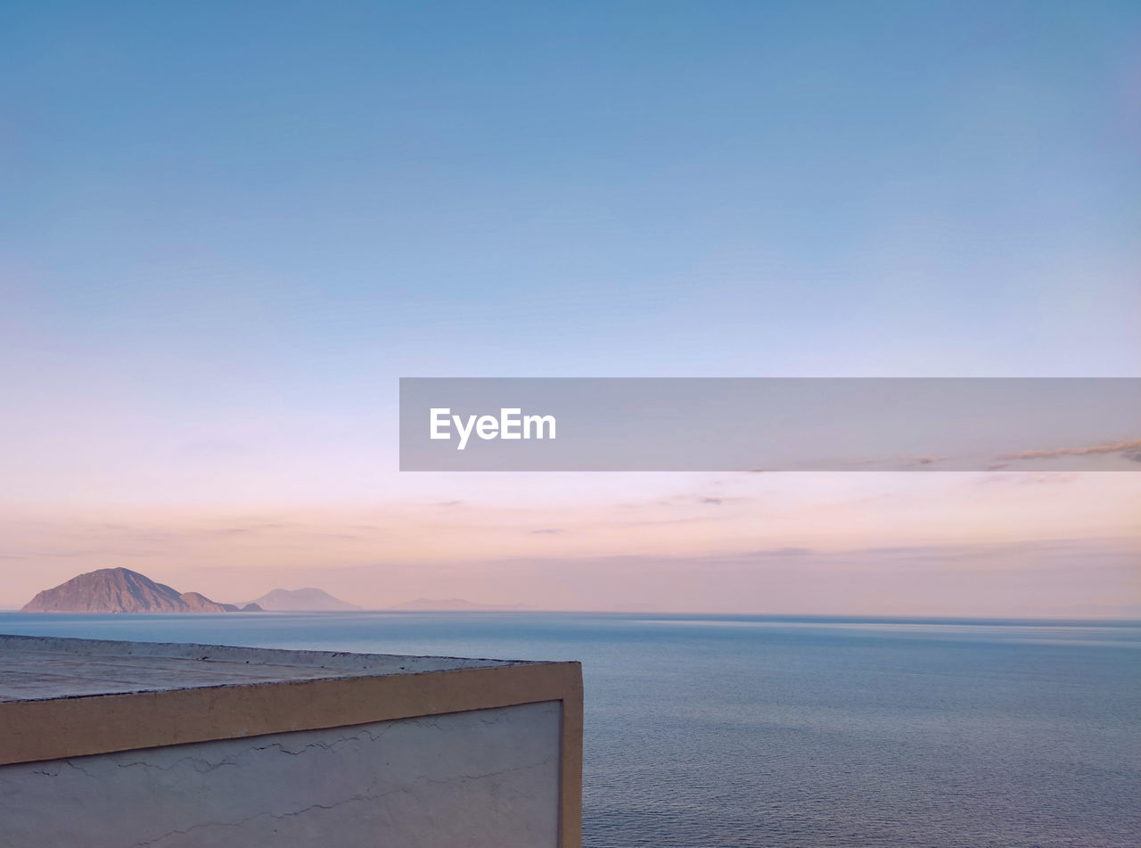 Scenic view of sea against sky during an island sunset.