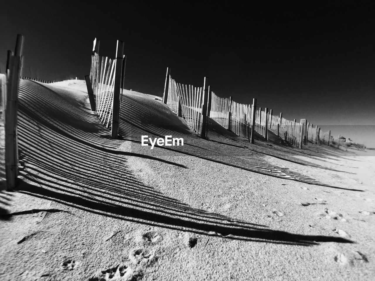 Wooden fences on sand