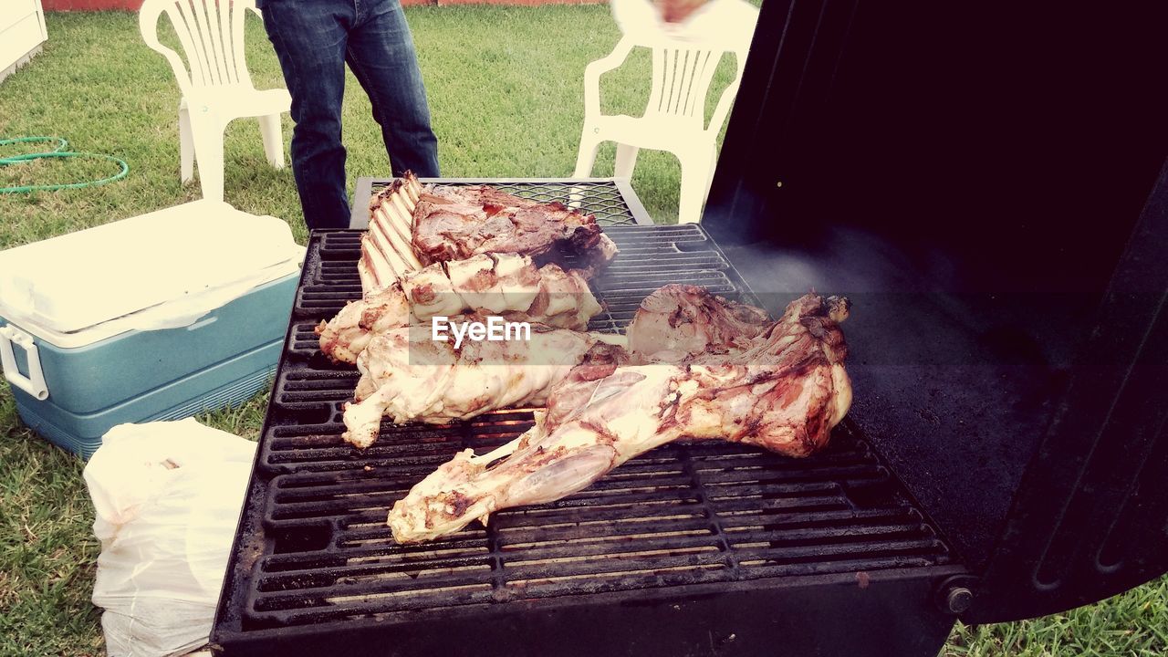 High angle view of goat meat on barbecue grill