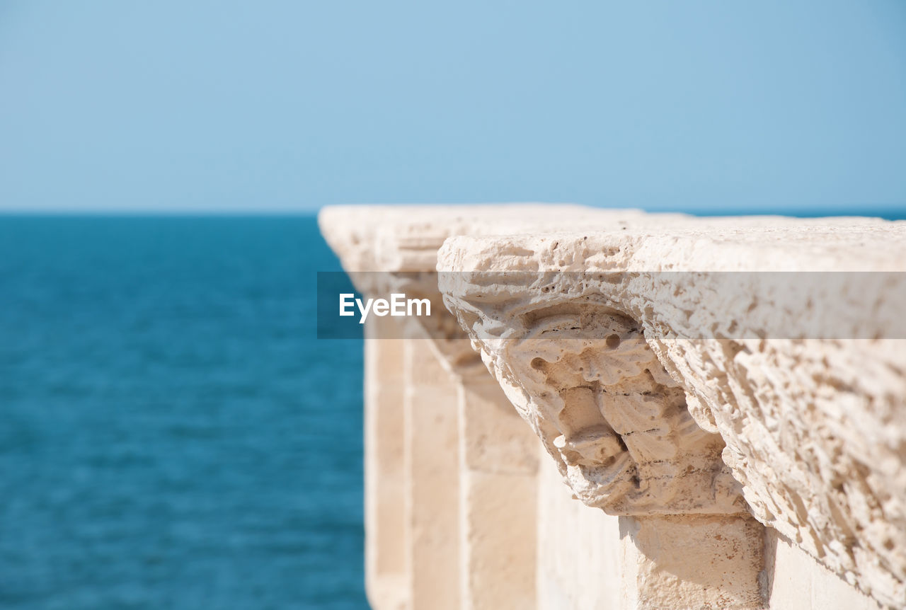 Detail of old architecture and blue sea background in italian city trani apulia