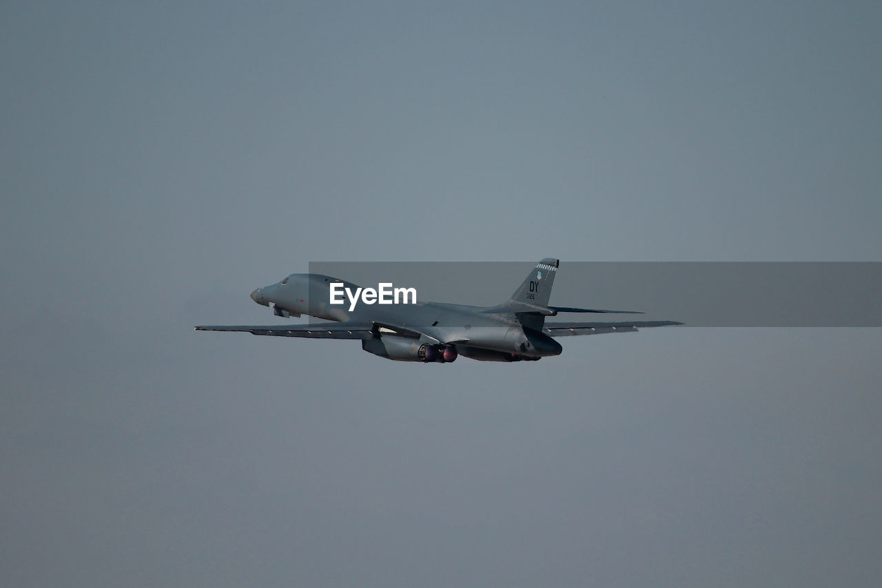 Low angle view of airplane flying against sky