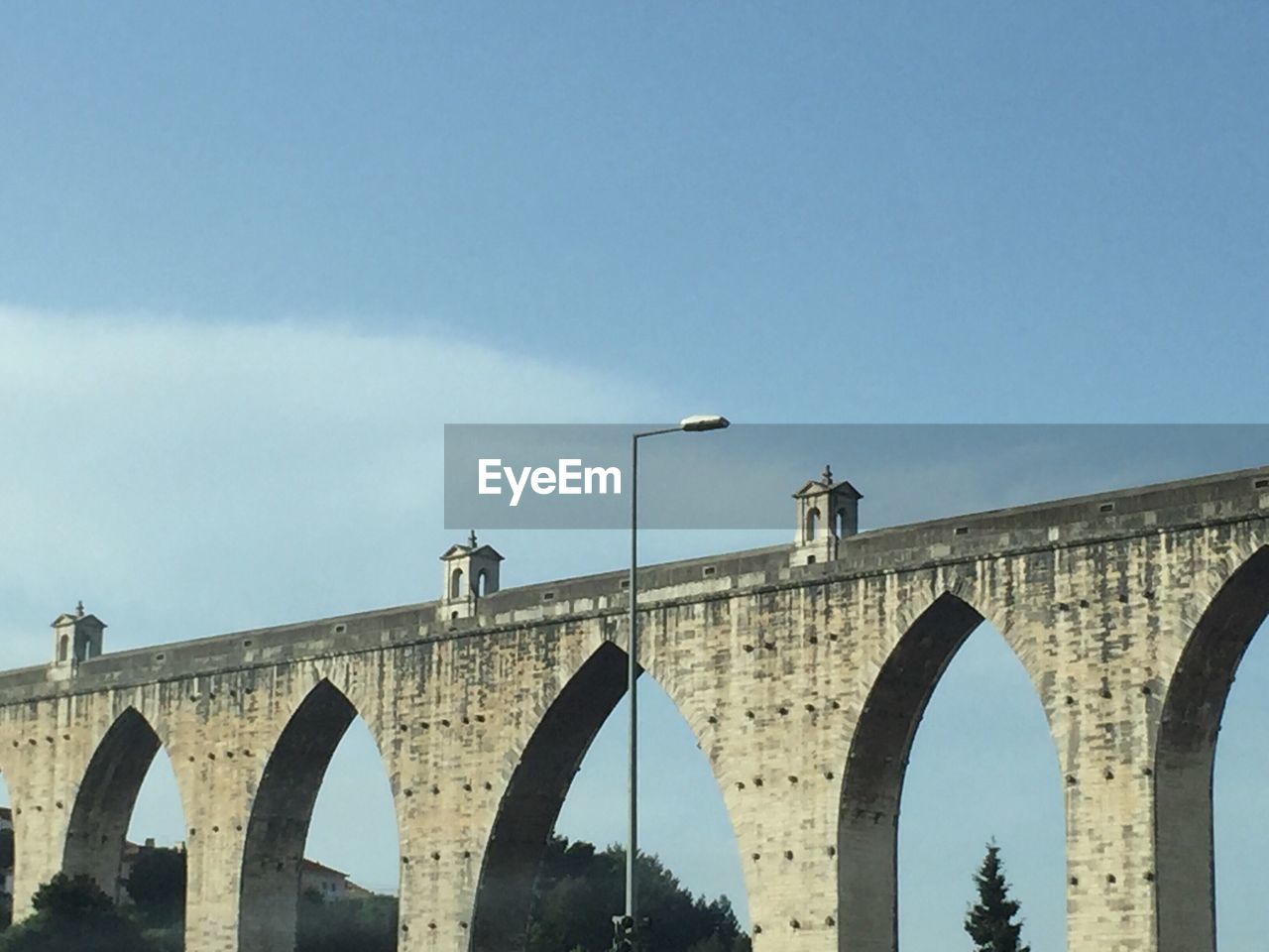 LOW ANGLE VIEW OF BRIDGE AGAINST BLUE SKY