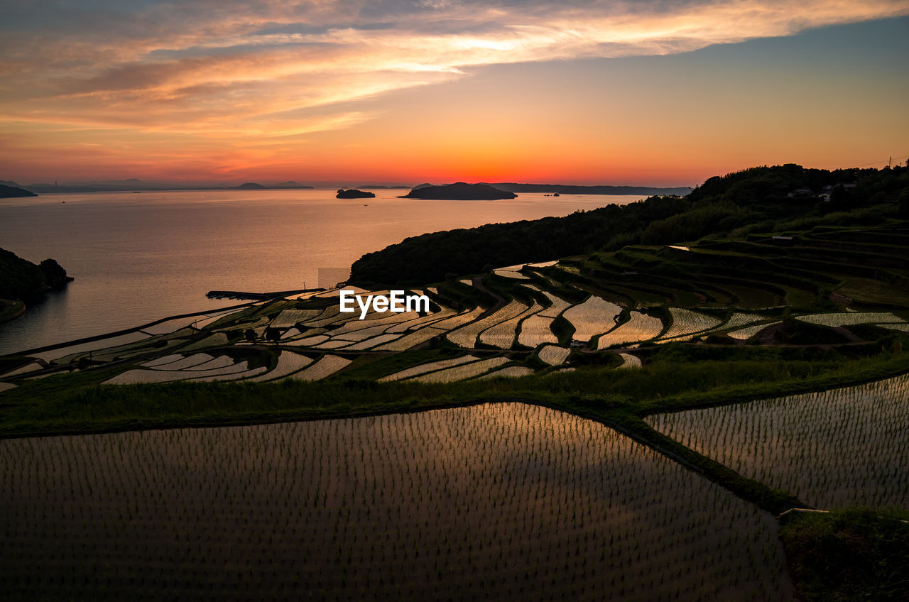 Scenic view of doya rice terrace against sky during sunset