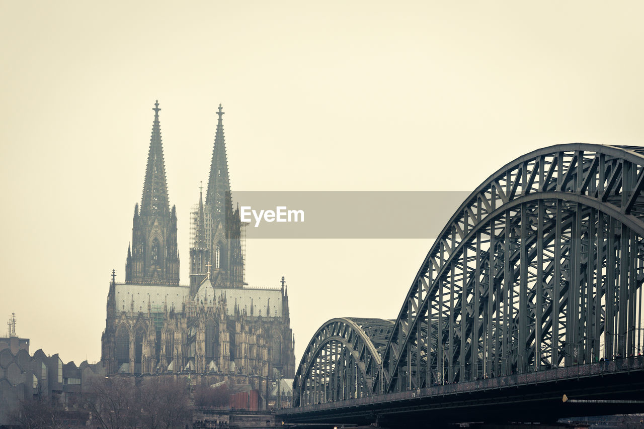 Cologne cathedral and hohenzollern bridge against clear sky in city