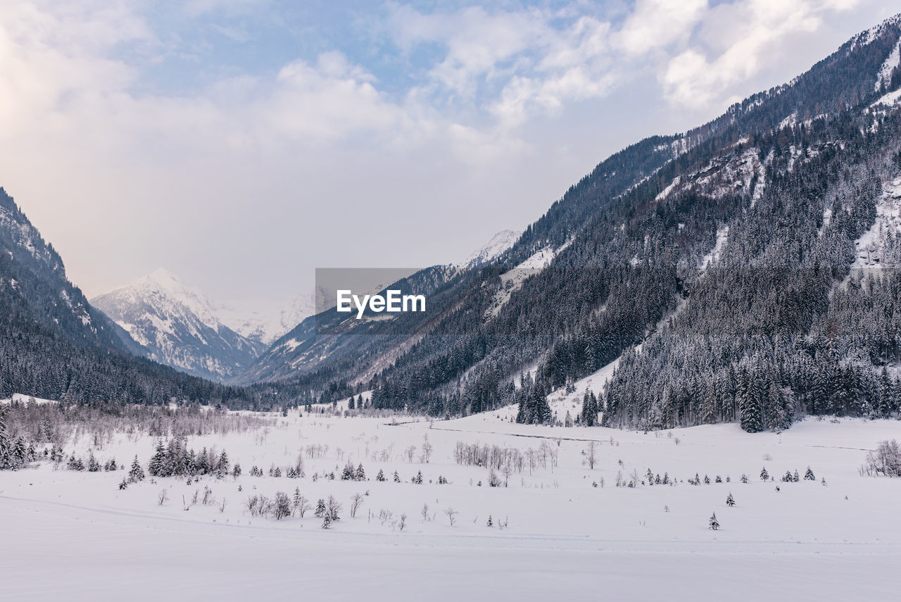 Scenic view of snowcapped mountains valley against sky. austrian apls in winter.