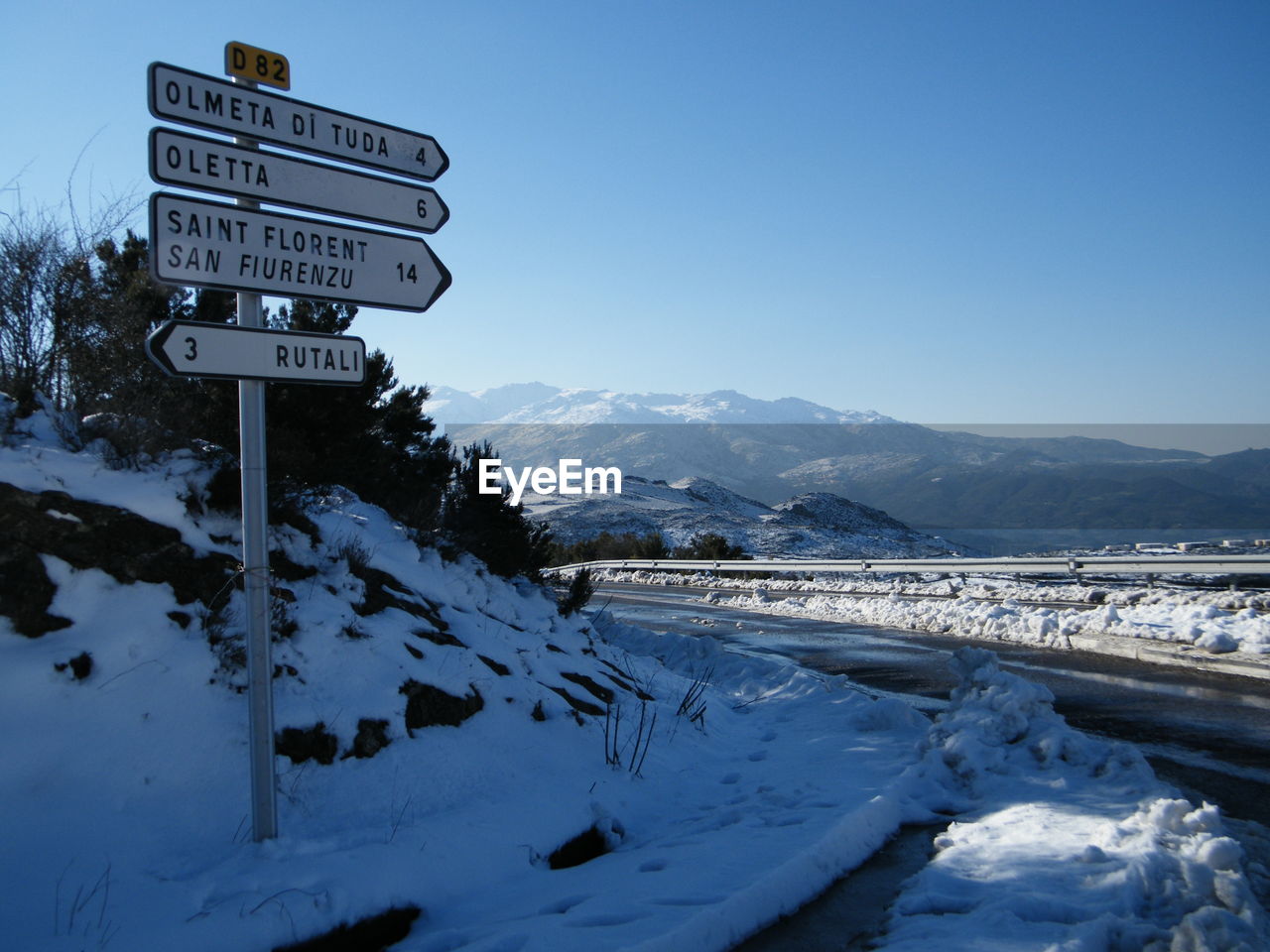 Arrow symbols with text at snow covered roadside