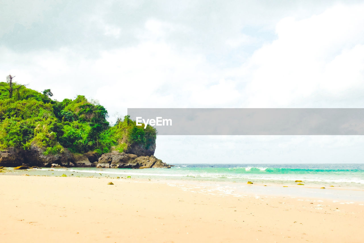 View of beach against cloudy sky