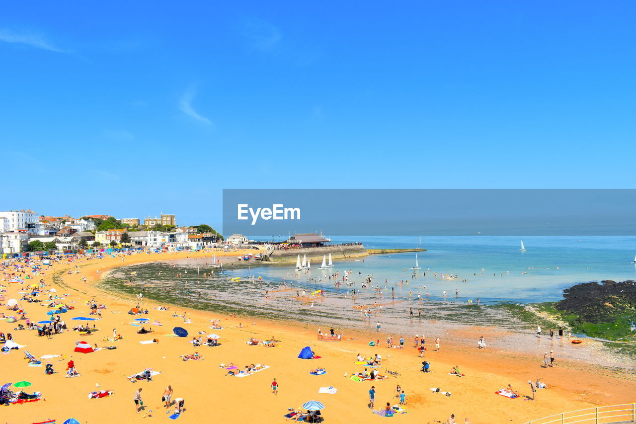 Tourists on summer holiday viking beach in broadstairs kent county is popular during school holidays