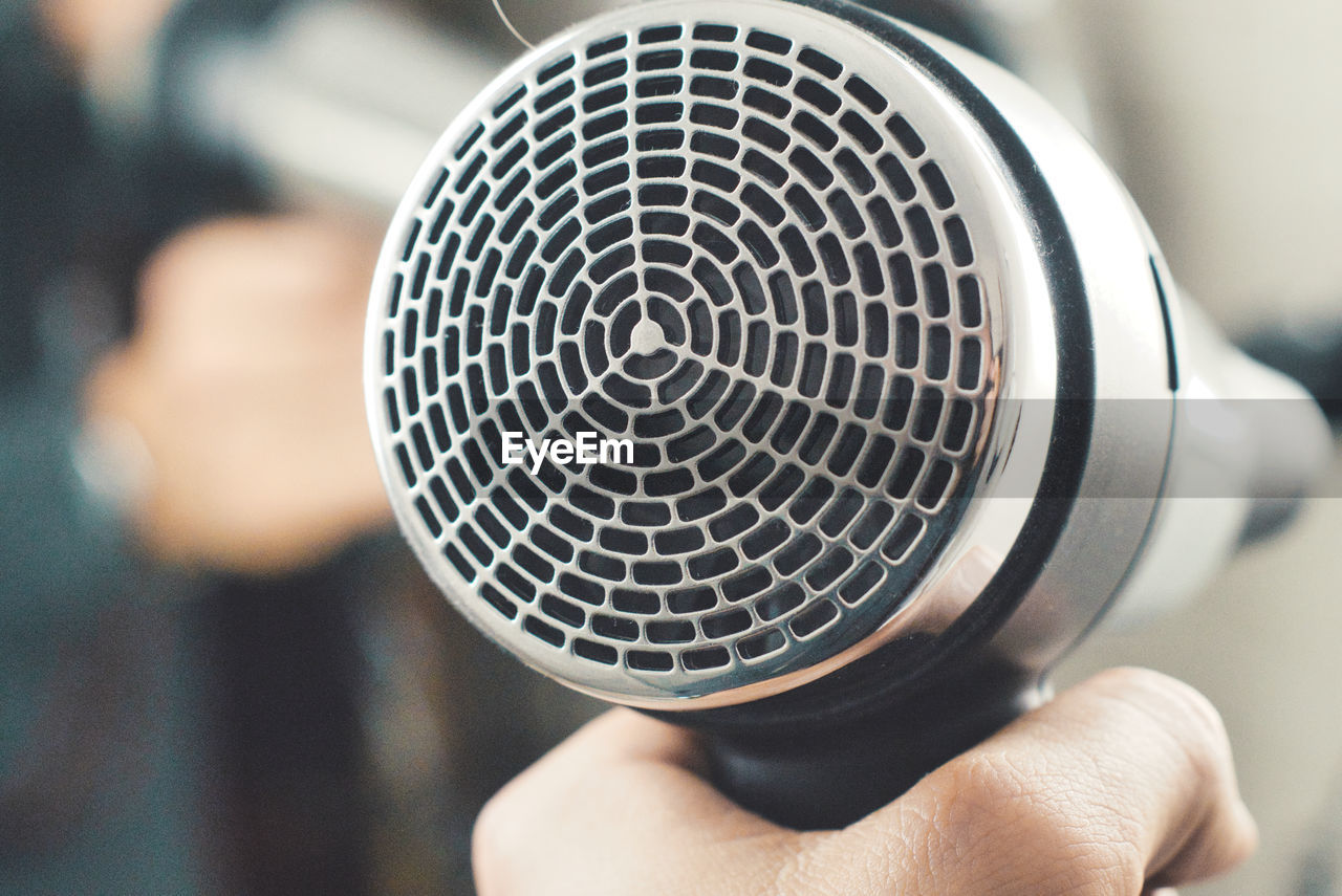 Close-up of hand holding hair dryer