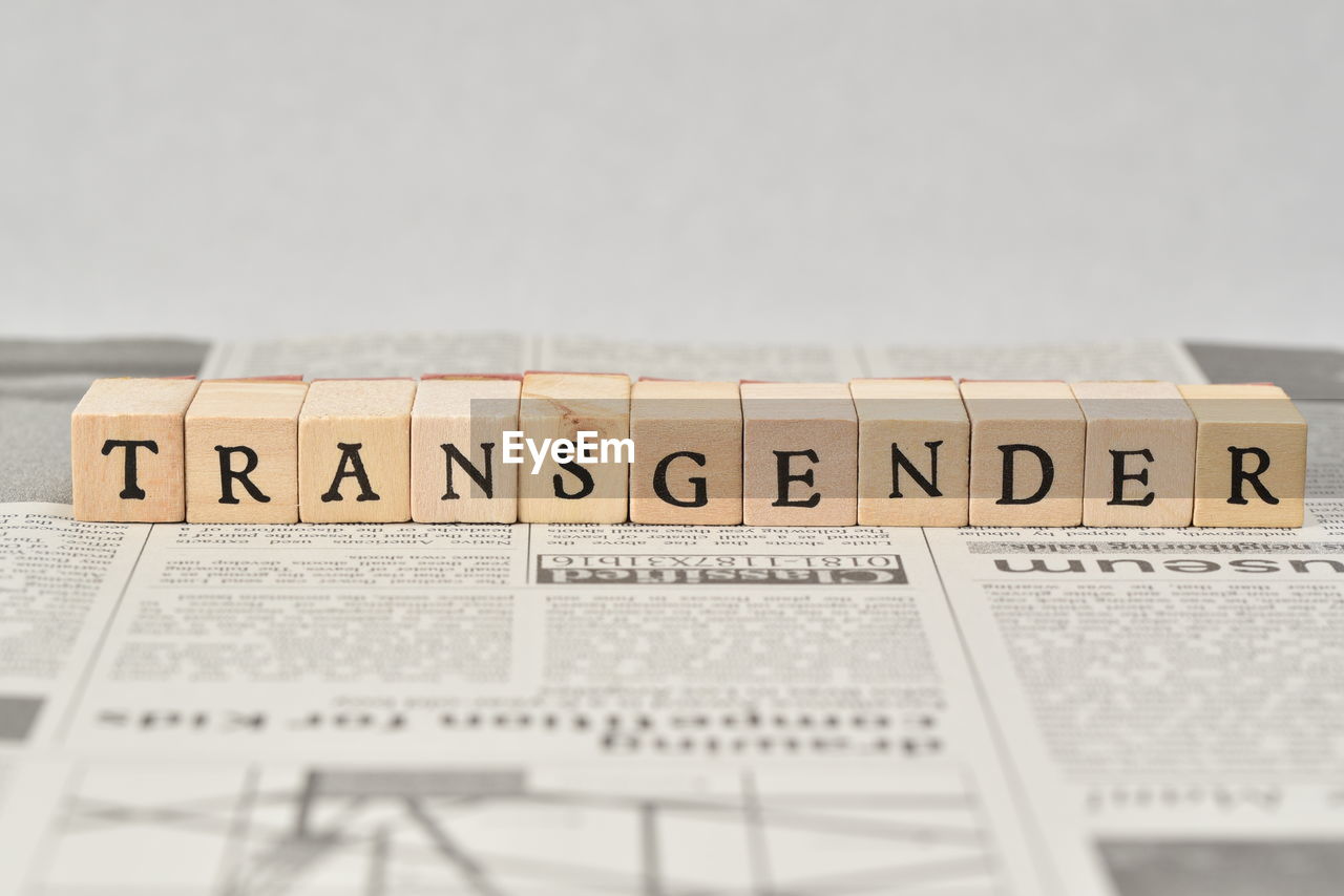 Close-up of transgender text blocks on newspaper