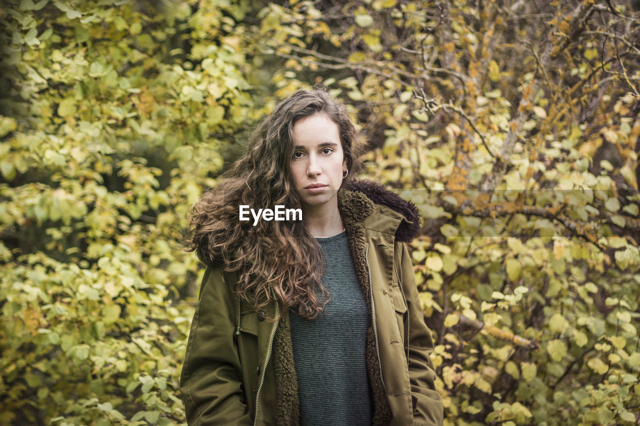 Portrait of beautiful young woman standing outdoors