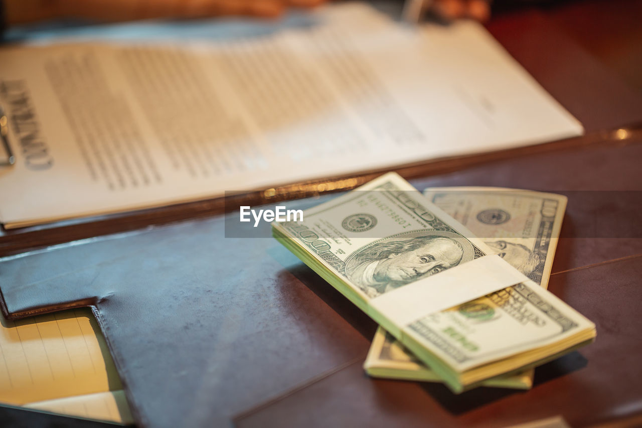 CLOSE-UP OF OPEN BOOK ON TABLE