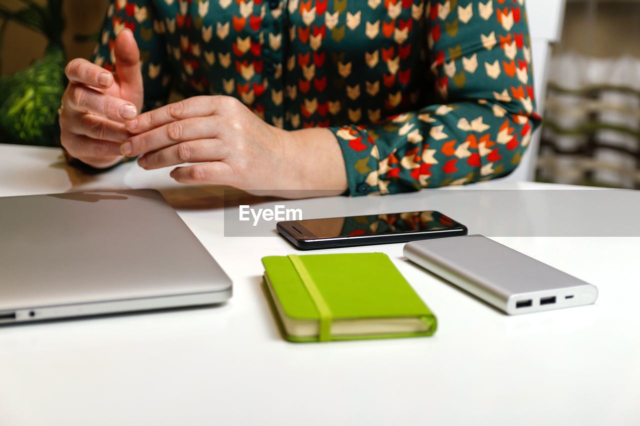 Unrecognizable elegant woman working on computer at office. start or finish of a work day. young