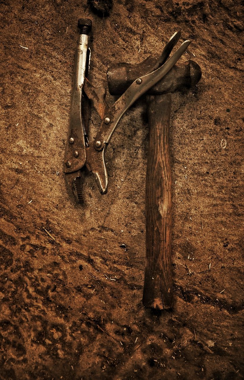 Close-up high angle view of tools on ground