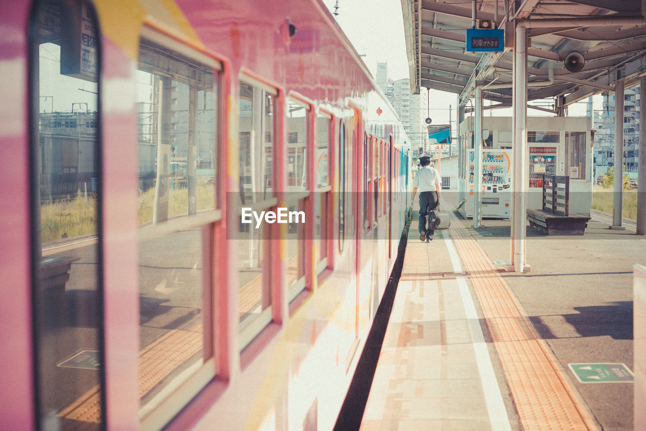 TRAIN AT RAILROAD STATION PLATFORM