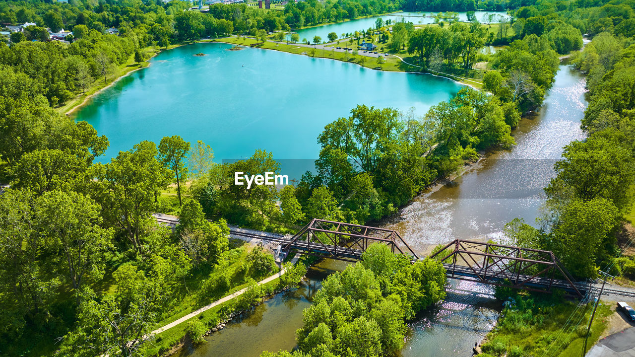 high angle view of river amidst trees against sky