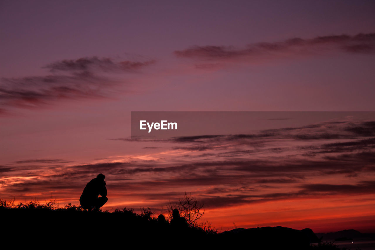 Silhouette landscape against sky during sunset