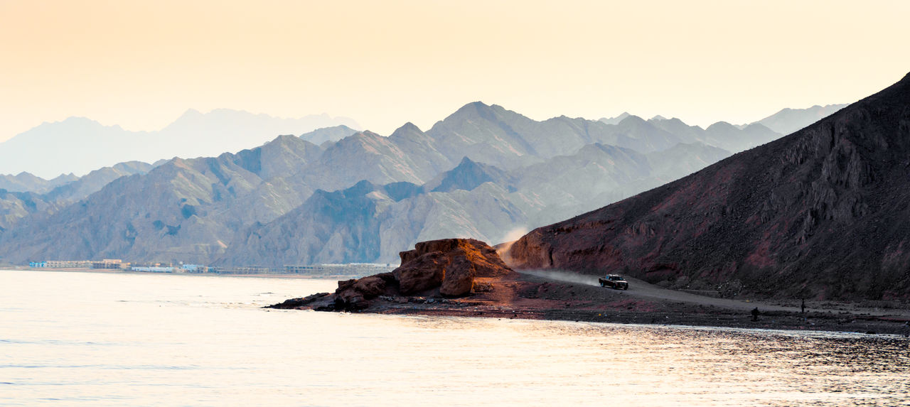 Scenic view of landscape and mountains against sky