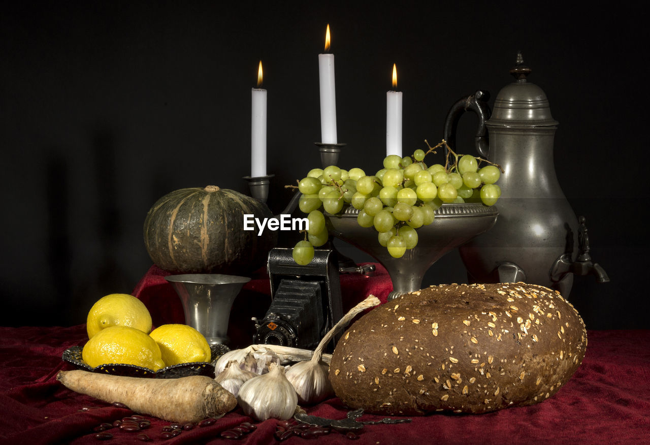 Close-up of food with vintage camera and candle on table