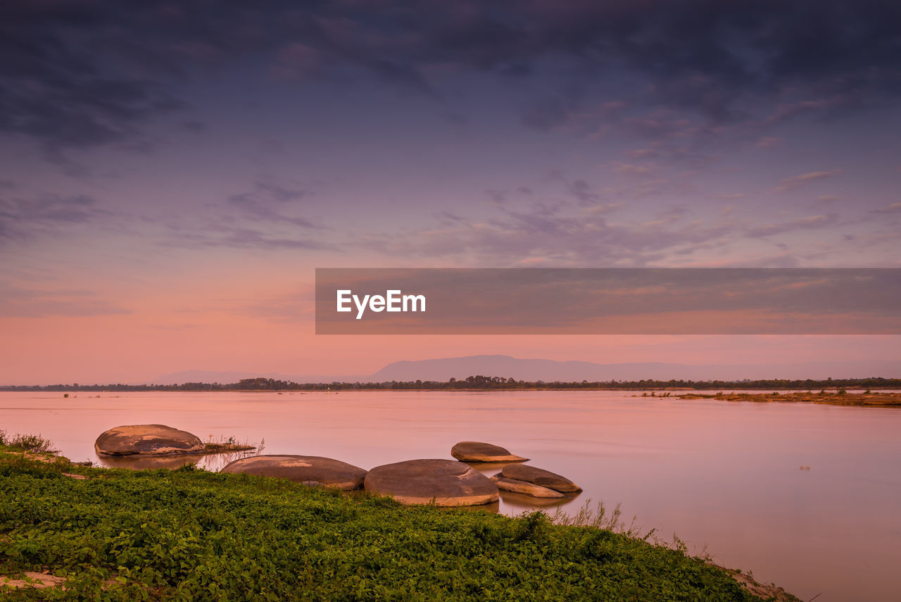 Scenic view of lake against sky during sunset