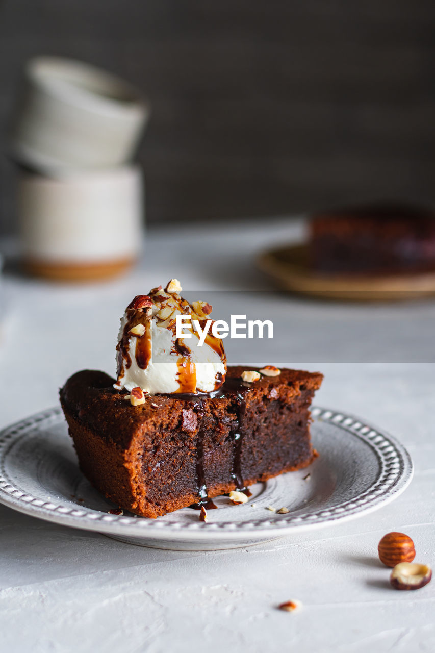 Chocolate cake with ice cream, nuts and chocolate sauce