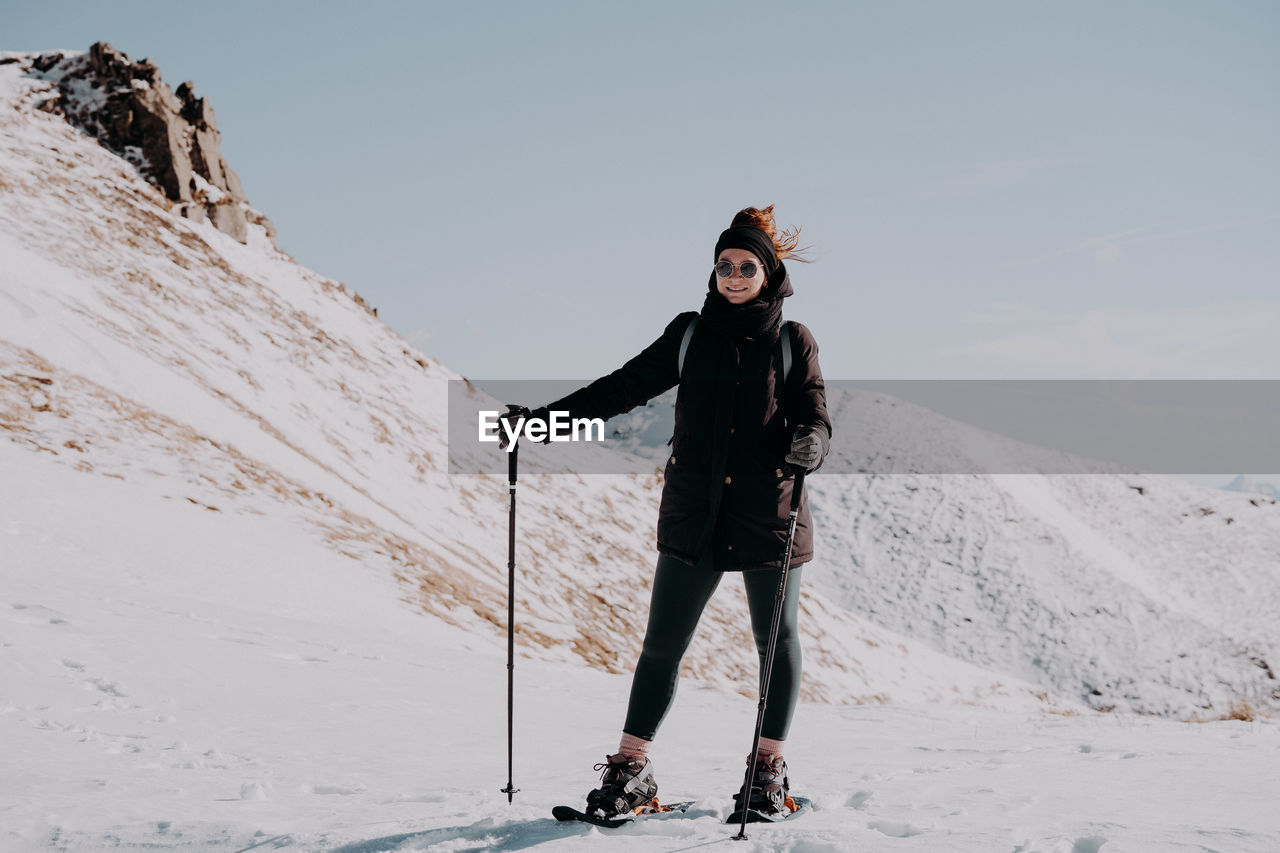 Full length of woman skiing on snow