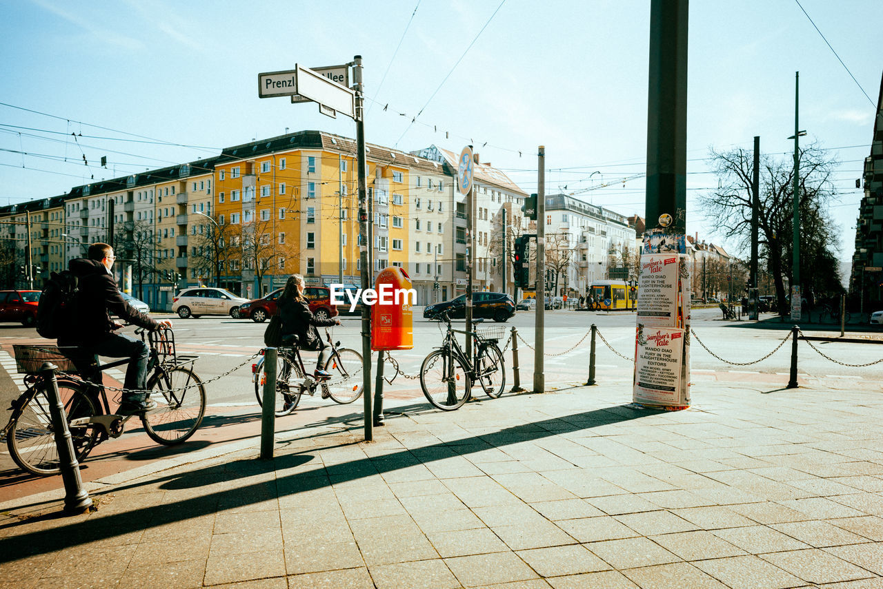 BICYCLES ON STREET BY BUILDINGS IN CITY