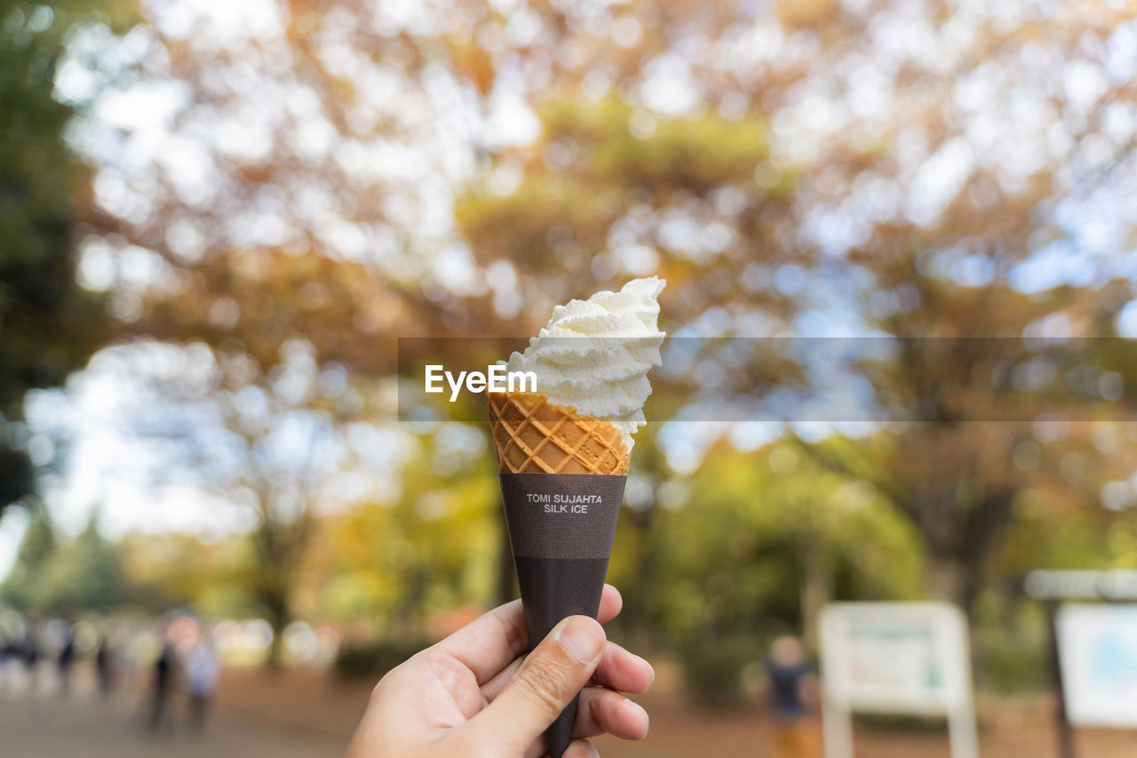 MIDSECTION OF PERSON HOLDING ICE CREAM CONE