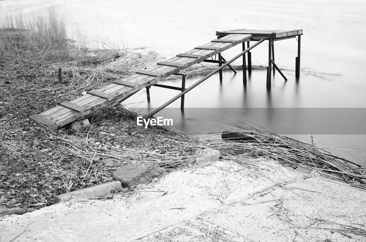 HIGH ANGLE VIEW OF RAILING ON SNOW FIELD