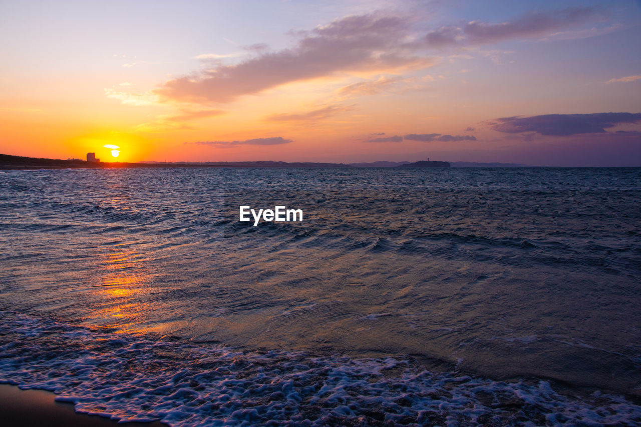 SCENIC VIEW OF BEACH AGAINST SKY DURING SUNSET