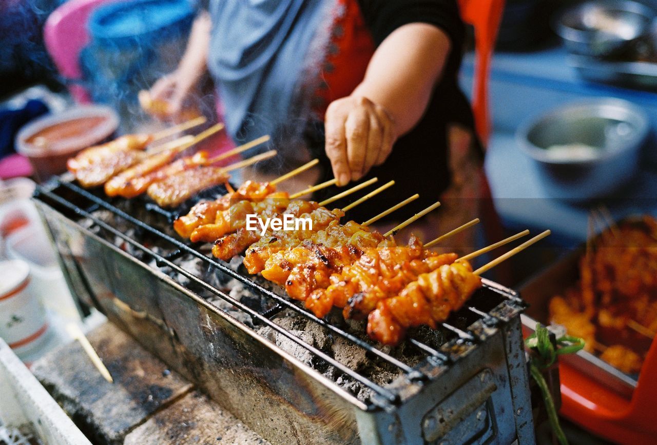 Man preparing food on barbecue grill