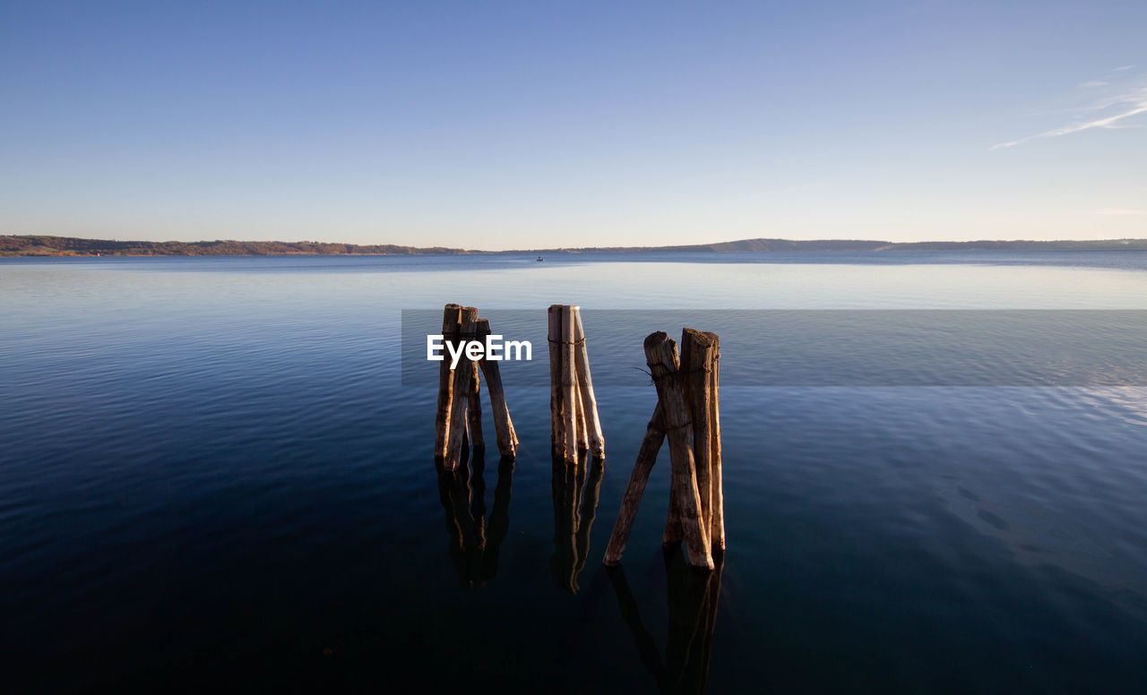 Landscape of lake bracciano in twilight with timber pier