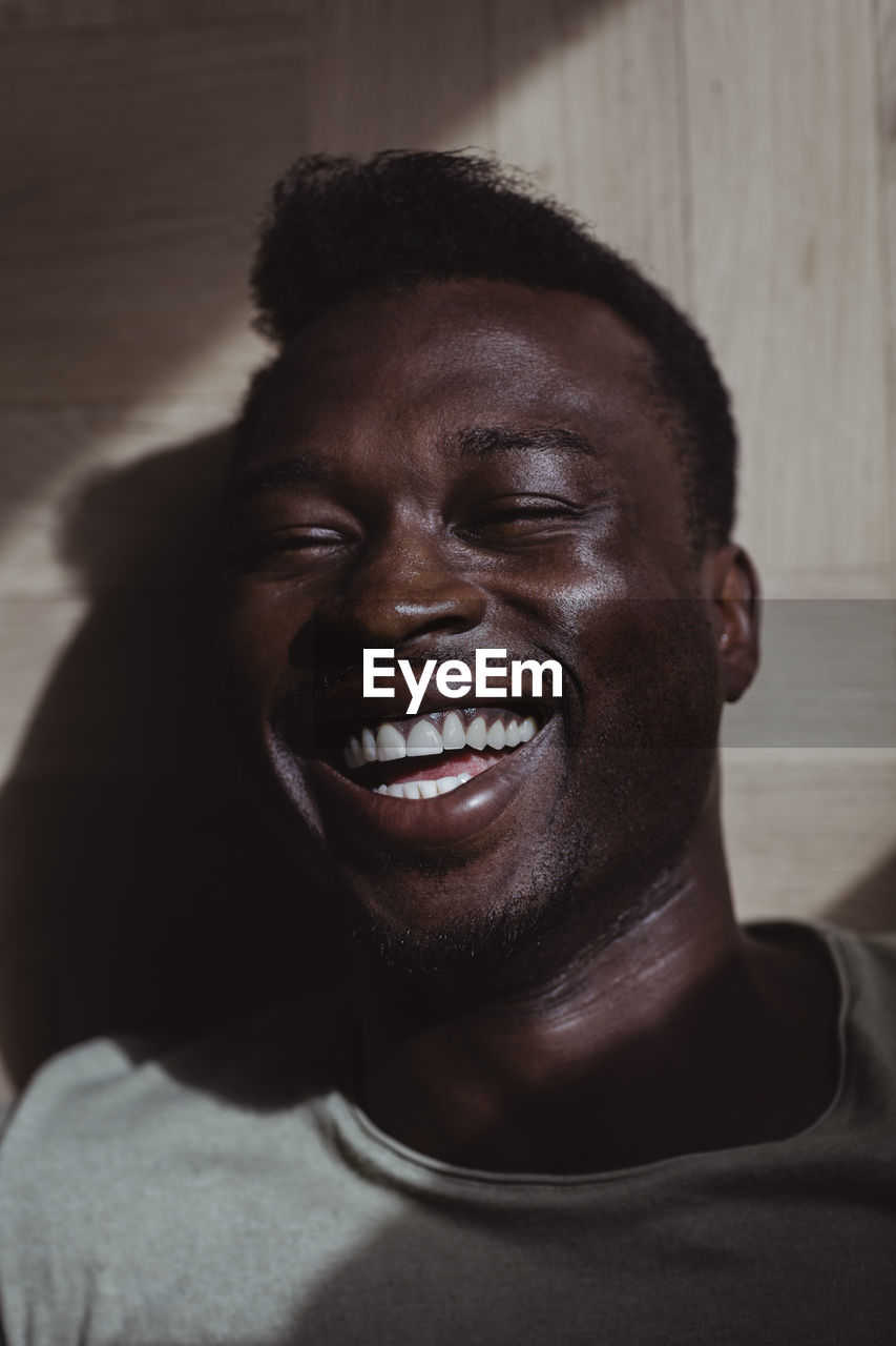 Close-up of smiling man at home