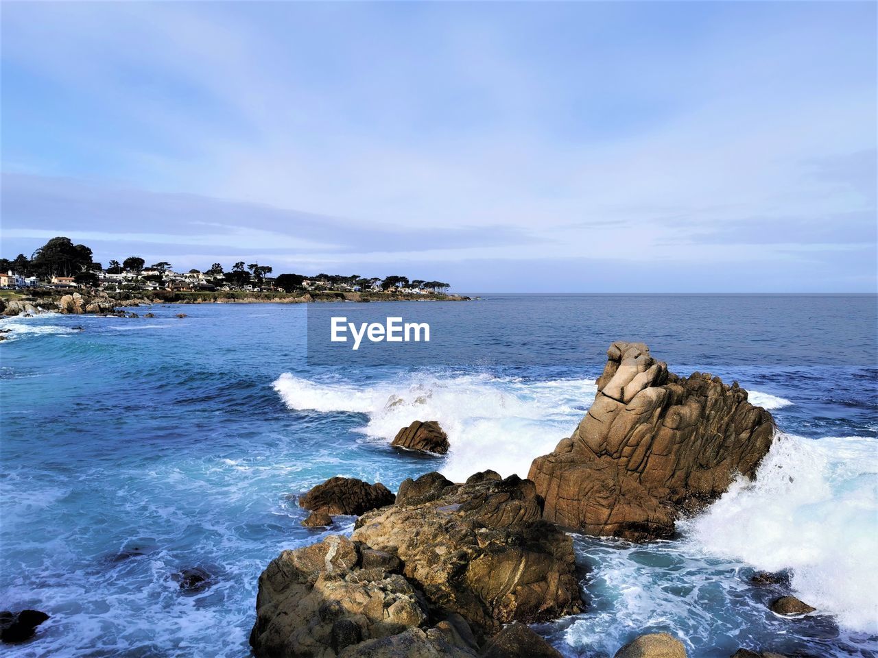 ROCKS ON SHORE AGAINST SKY