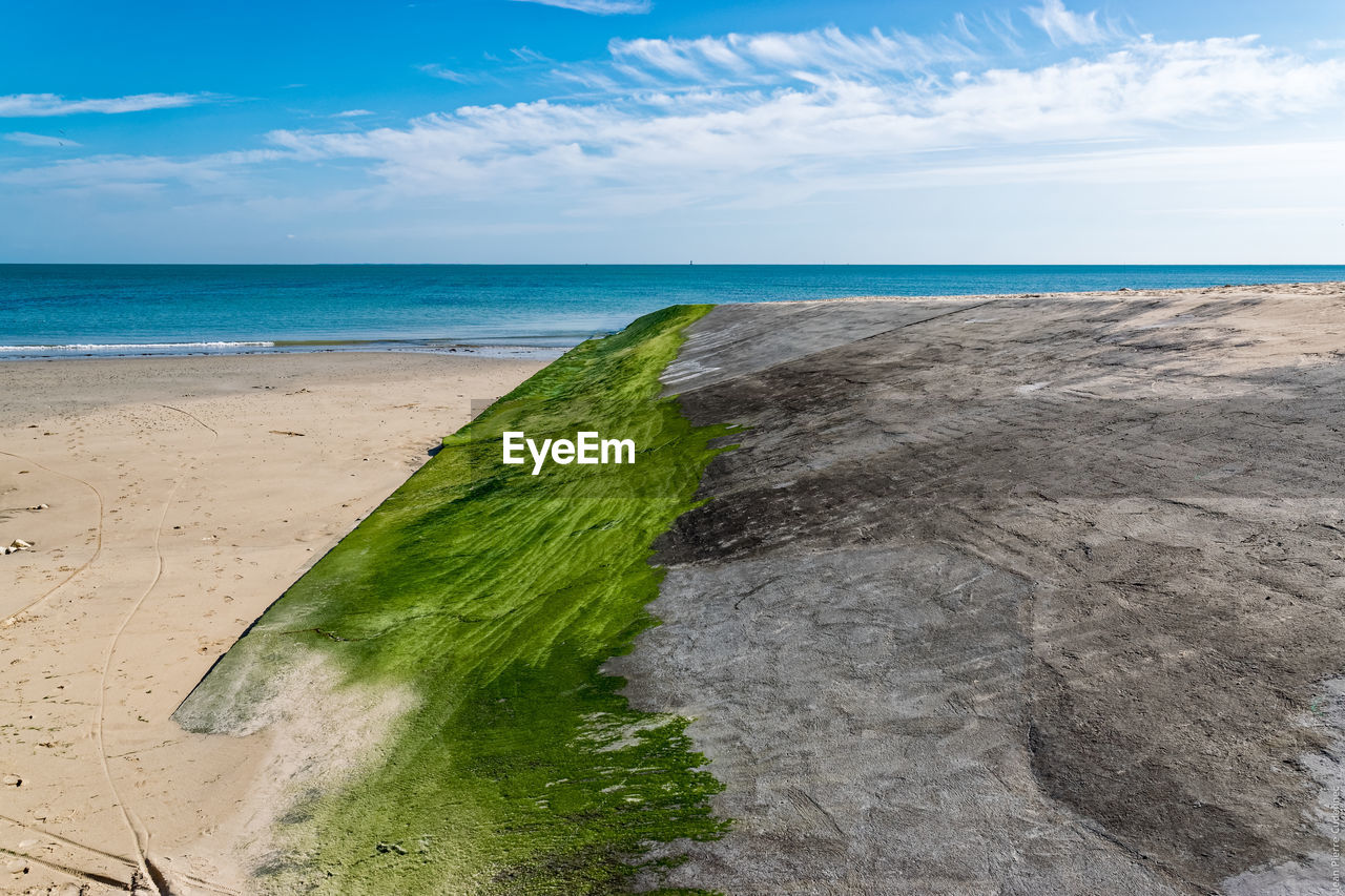 Scenic view of beach against blue sky